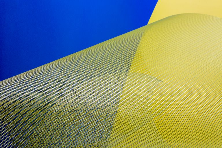 Intriguing abstract art with yellow and blue mesh against a vibrant background, ideal for modern design.